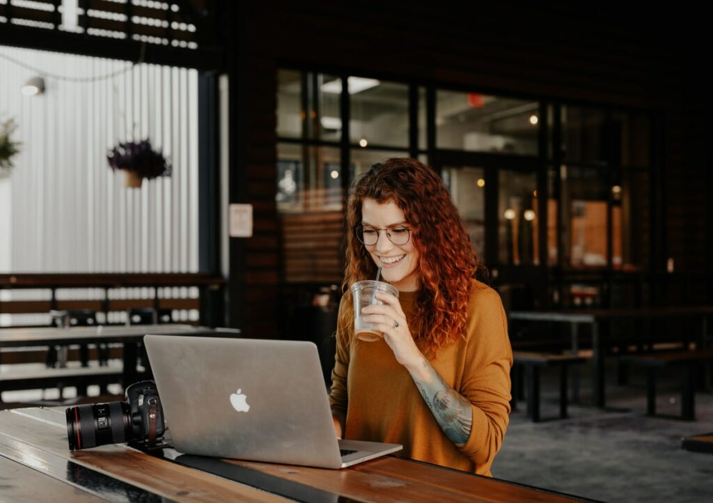 A woman working in front of her laptop at a café